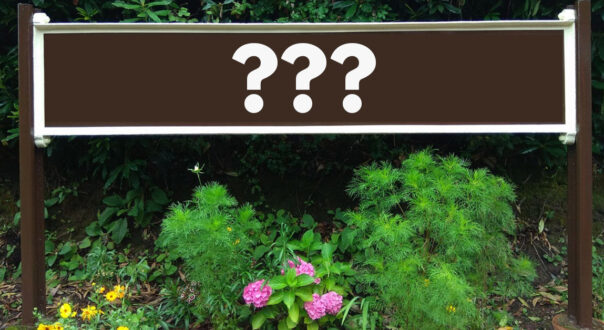 Station signage with question marks superimposed