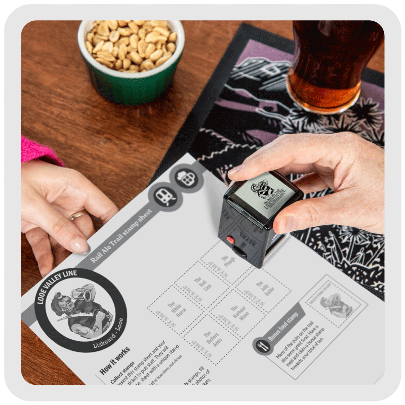 Stamping the Looe Valley Line stamp sheet