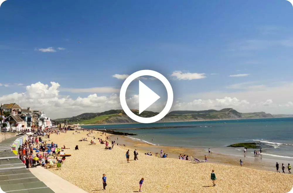 Lyme Regis beach with play button superimposed