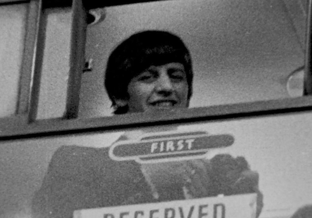 Ringo Starr looks out from train's First Class carriage