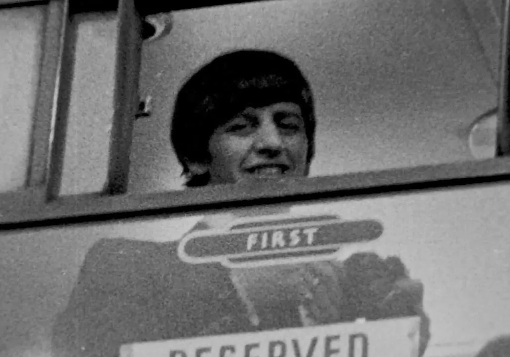 Ringo Starr looks out from train's First Class carriage