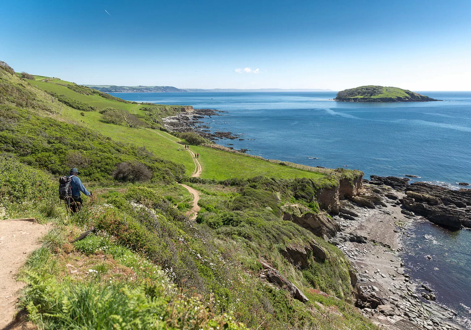 Man walking the South West Coast Path between Looe and Polperro